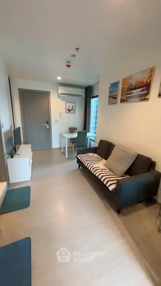 Modern living room with cozy sofa and dining area in a stylish apartment.