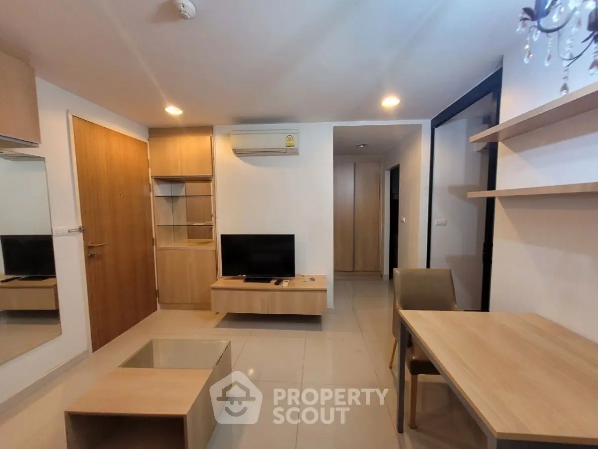 Modern living room with sleek furniture and built-in storage, perfect for urban living.