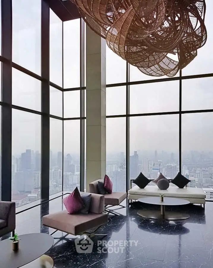 Luxurious high-rise living room with panoramic city views and modern decor.