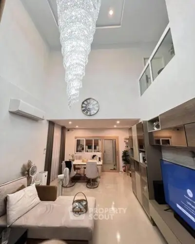 Luxurious modern living room with high ceiling and elegant chandelier