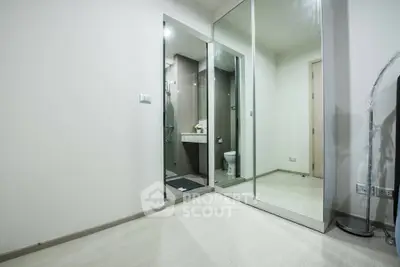 Modern bathroom with mirrored closet doors and sleek design