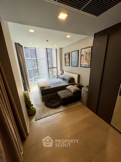 Modern bedroom with large windows and stylish decor in urban apartment