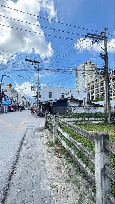 Urban street view with residential buildings and clear blue sky.