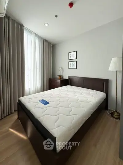 Spacious bedroom with modern decor and natural light