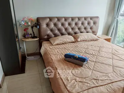 Cozy bedroom with plush headboard and scenic window view