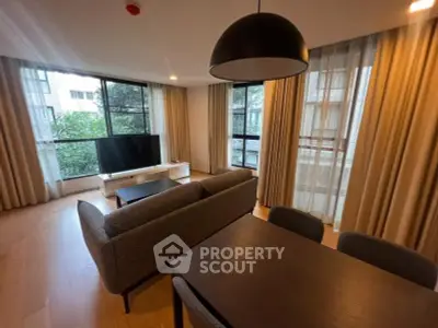 Spacious living room with modern furniture and large windows offering natural light.
