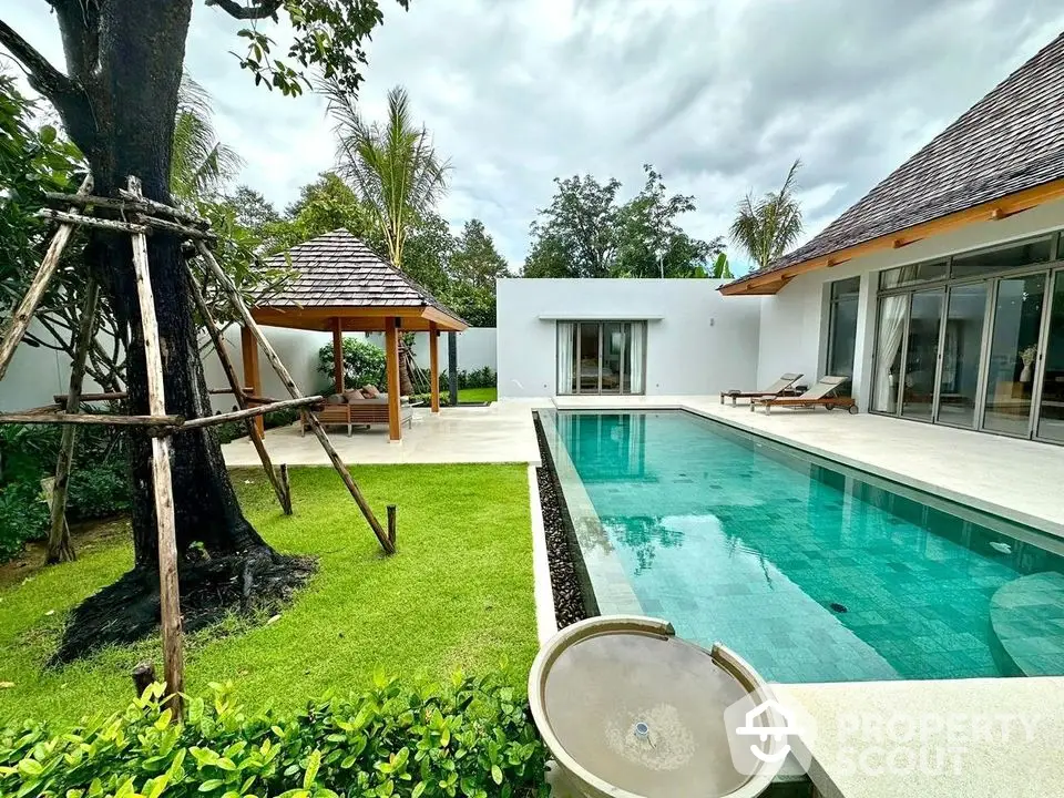 Luxurious villa with private pool and lush garden, featuring modern architecture and serene outdoor space.