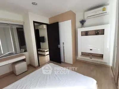 Modern bedroom with air conditioning and minimalist decor in a stylish apartment.