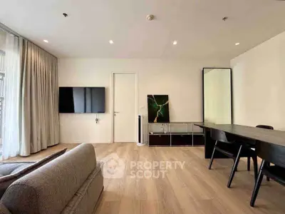 Spacious modern living room with sleek furniture and wall-mounted TV