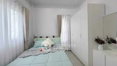 Cozy bedroom with modern decor and ample natural light