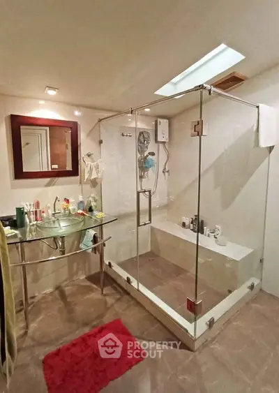 Modern bathroom with glass shower enclosure and stylish sink