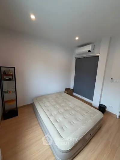 Cozy bedroom with air mattress and modern air conditioning unit