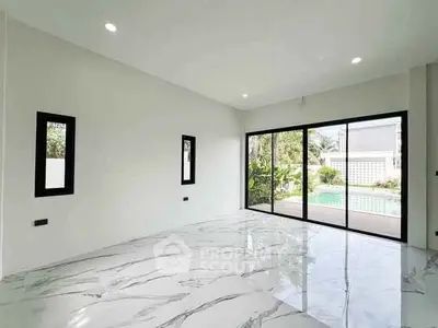 Spacious modern living room with marble flooring and pool view