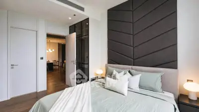 Modern bedroom with stylish decor and cozy ambiance in a luxury apartment.