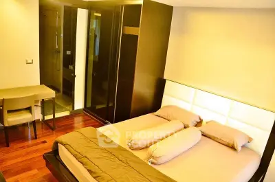 Modern bedroom with elegant wooden flooring and stylish furniture