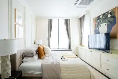 Luxurious bedroom with elegant decor, large windows, and modern furnishings in a high-end apartment.