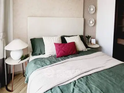 Cozy bedroom with stylish decor and plush bedding