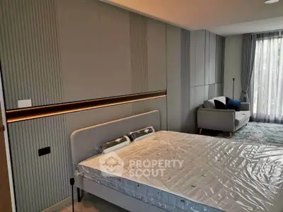 Modern bedroom with stylish decor and cozy seating area