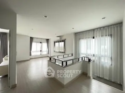 Spacious modern living area with large windows and sleek design, perfect for family gatherings.