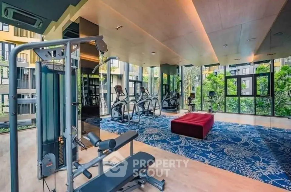Modern gym with state-of-the-art equipment and scenic views in luxury apartment complex.