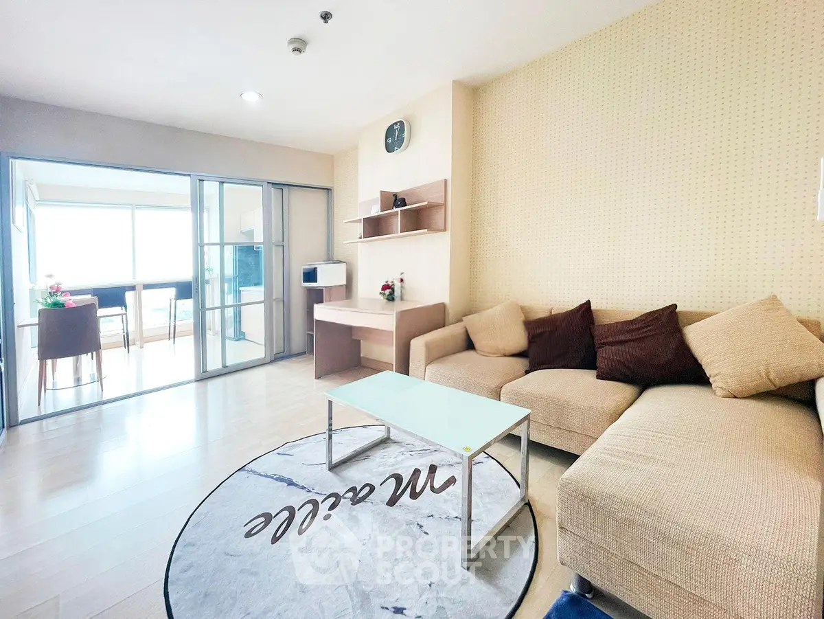 Spacious living room with modern decor and cozy seating area, perfect for relaxation and entertaining.