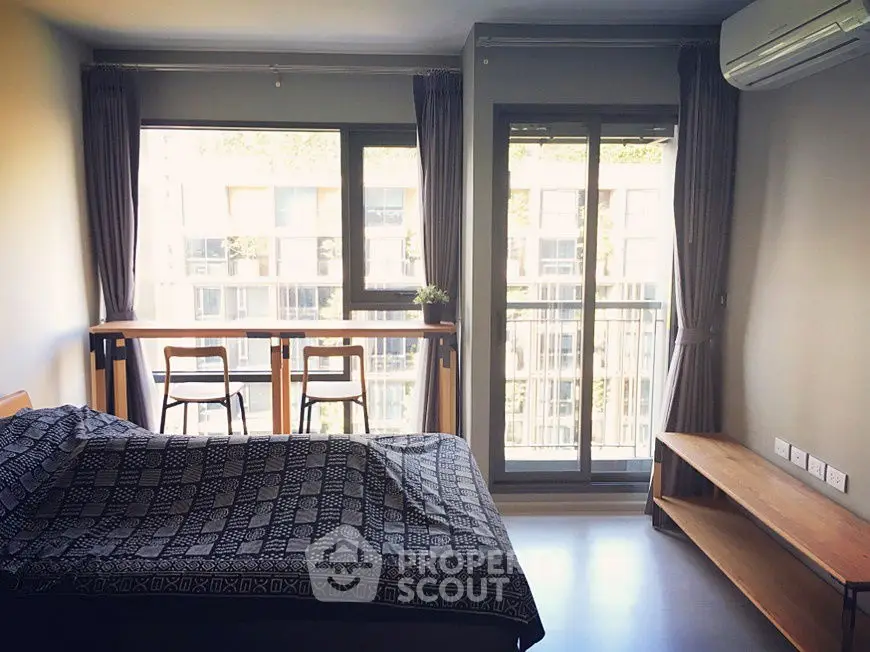 Modern bedroom with balcony view and natural light