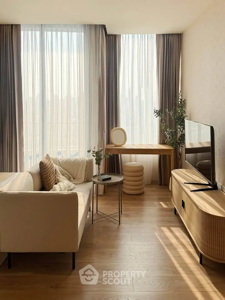 Elegant living room with modern furniture, large windows, and abundant natural light.
