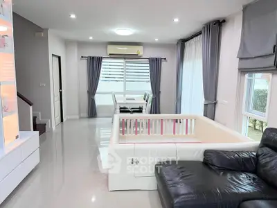Spacious modern living room with sleek furniture and large windows
