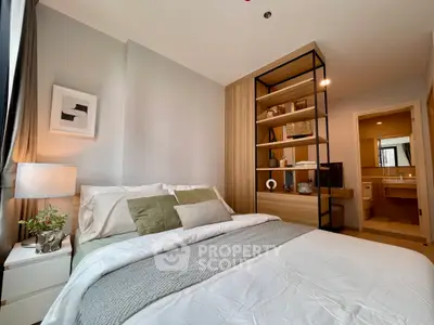 Modern bedroom with stylish decor and ensuite bathroom in a cozy apartment.