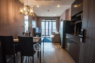 Modern open-plan kitchen and living area with stylish decor and natural light.