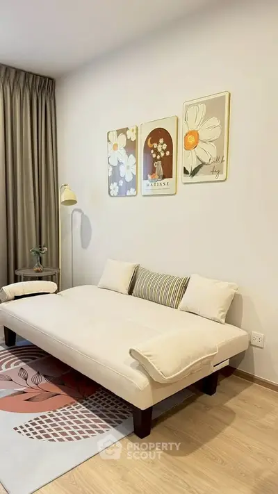 Cozy living room with modern decor and stylish wall art, featuring a comfortable sofa and elegant lighting.