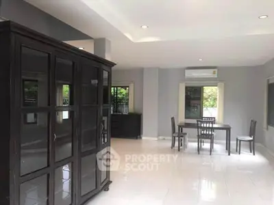Spacious living room with modern furniture and large windows for natural light.