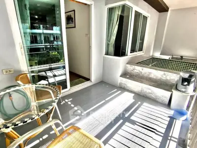 Modern balcony with jacuzzi and stylish outdoor seating