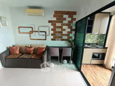 Modern living room with stylish decor and compact kitchen area