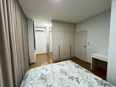 Spacious bedroom with modern wardrobe and elegant decor in a stylish apartment.