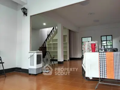 Spacious open-plan living area with tiled flooring and modern decor