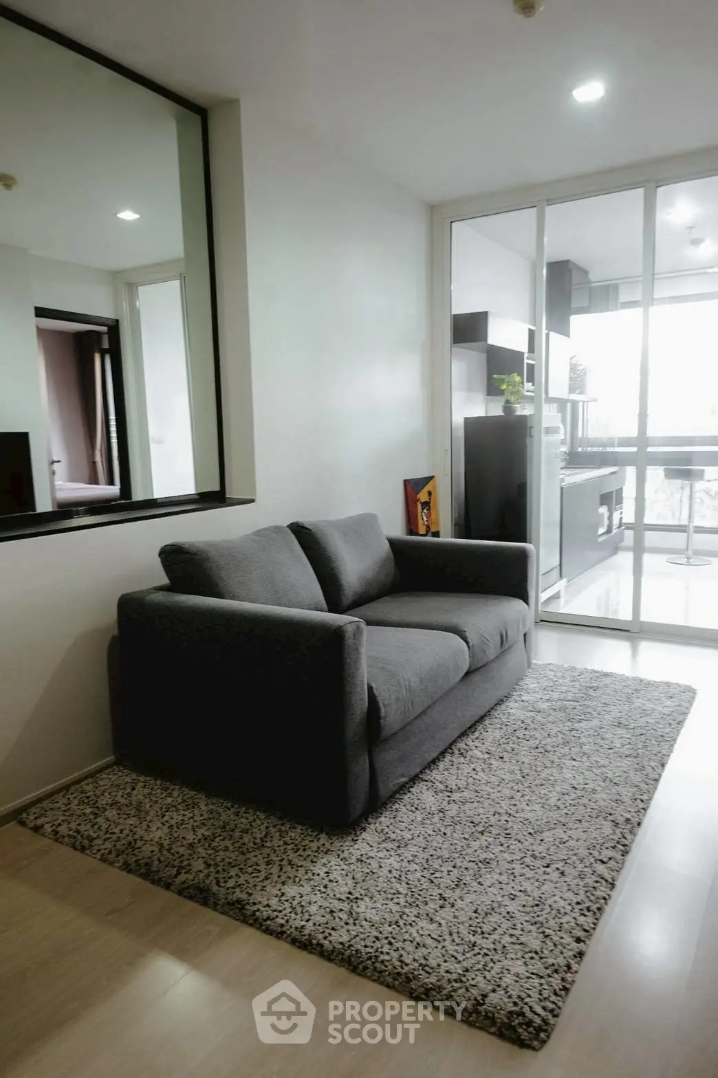 Modern living room with cozy gray sofa and stylish decor