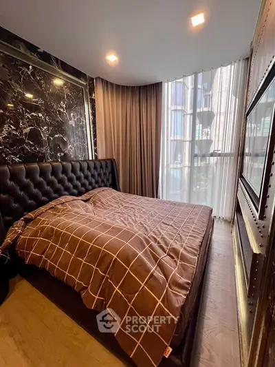 Luxurious bedroom with modern design and large window for natural light