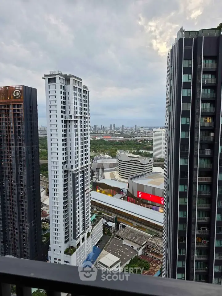 Stunning cityscape view from high-rise balcony with modern skyscrapers and urban skyline.