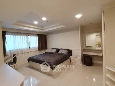 Spacious bedroom with modern decor and natural light