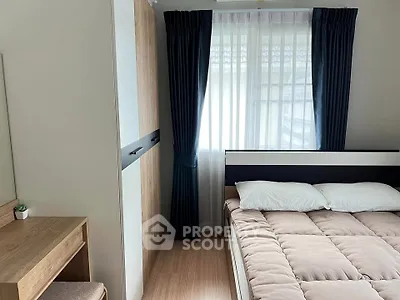 Cozy bedroom with modern decor, featuring a comfortable bed, stylish wardrobe, and natural light through large window.
