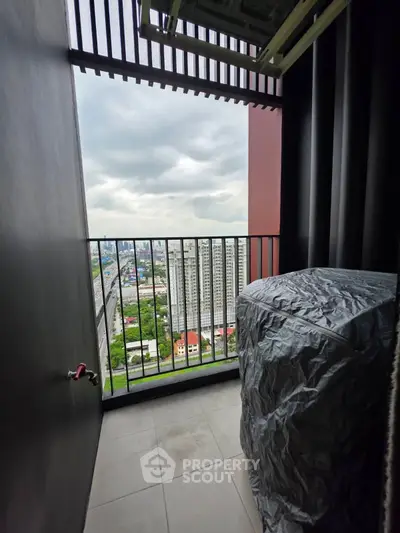 High-rise balcony with city view and covered outdoor unit, perfect for urban living.