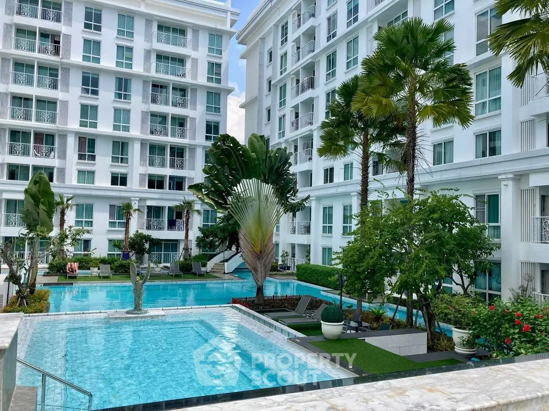 Luxurious condominium with stunning pool and lush garden in modern residential complex.