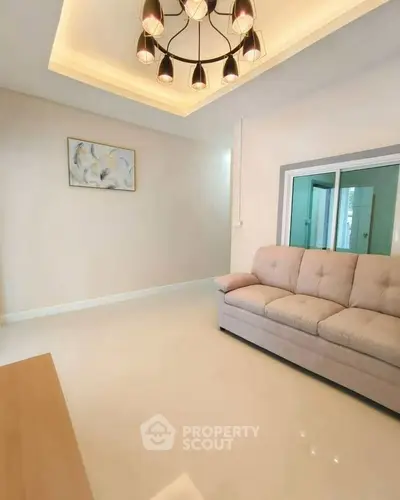 Modern living room with elegant lighting and cozy sofa in a stylish apartment.