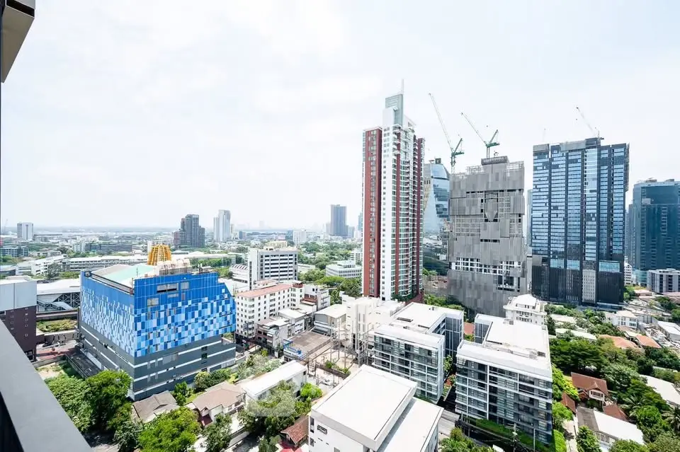 Stunning cityscape view from a high-rise building balcony, showcasing modern skyscrapers and urban skyline.