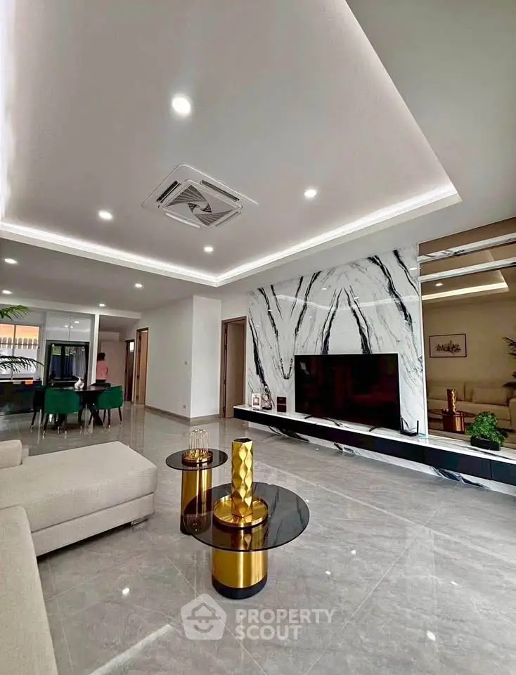 Luxurious modern living room with marble accent wall and stylish furniture