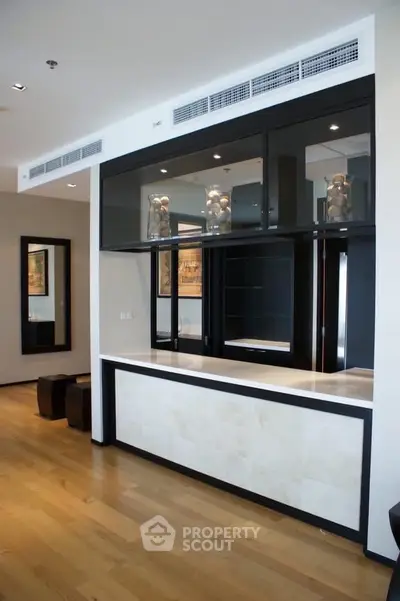 Modern interior with sleek bar counter and wooden flooring, ideal for stylish living spaces.