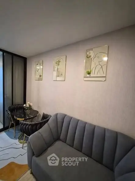 Stylish living room with modern sofa and chic wall art in cozy apartment.