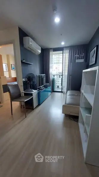 Modern living room with sleek furniture and balcony view in urban apartment