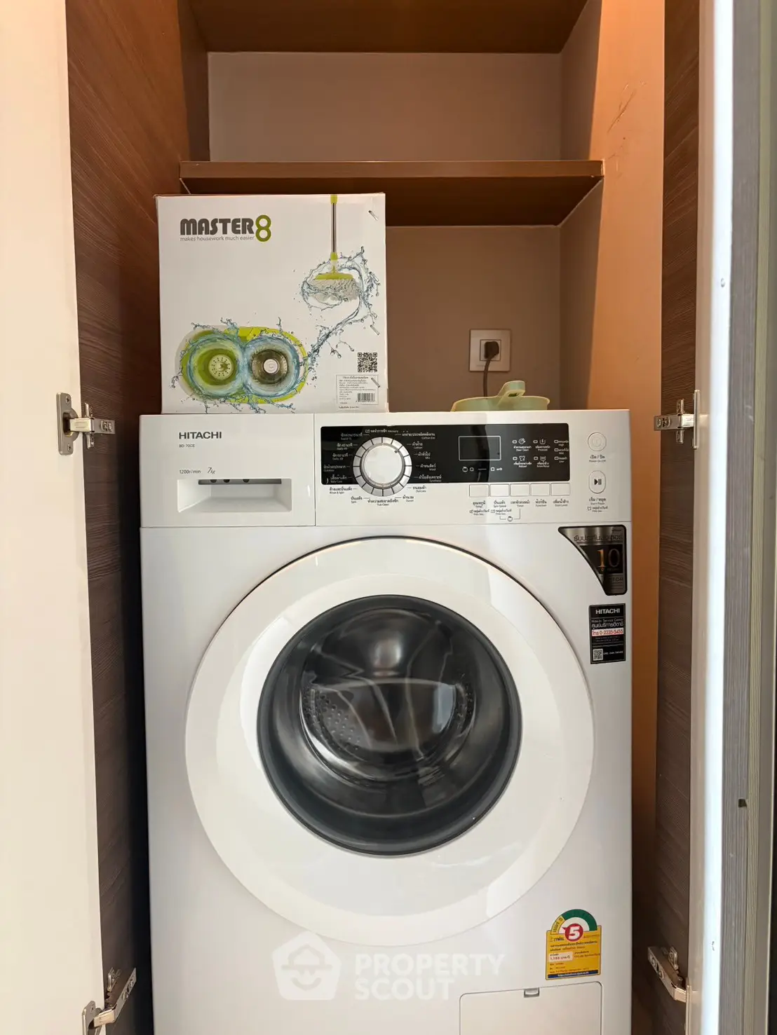 Compact laundry space with modern washing machine in a cozy apartment setting.